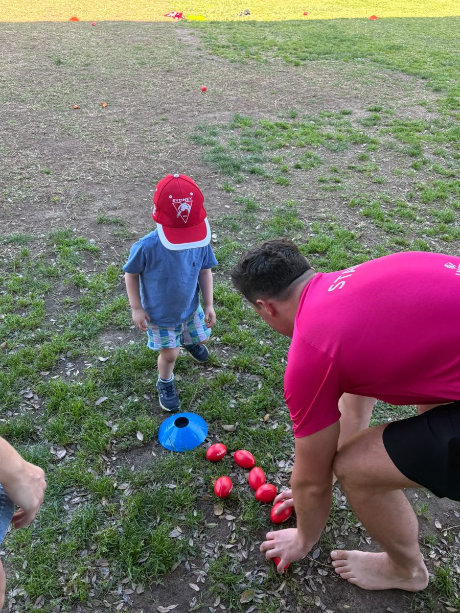 A toddler playing a cone game with Coach Jo